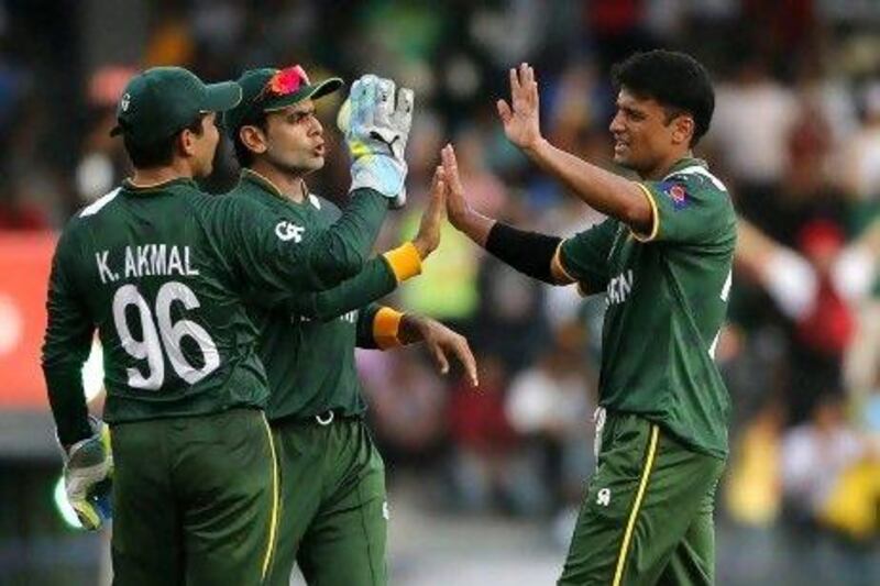 Mohammad Hafeez, centre, had Yasir Arafat, right, open the bowling but continued to show faith in his other bowlers.
