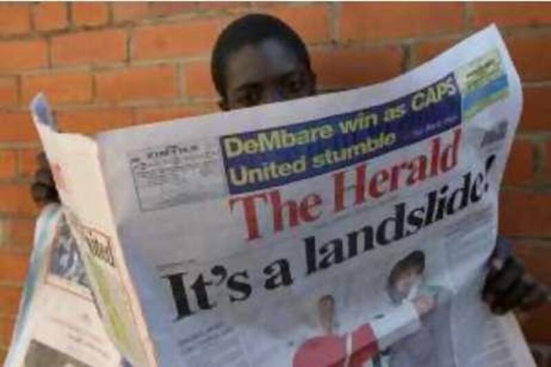 A man reads a copy of the state owned daily newspaper, 'The Herald' a day after President Robert Mugabe was sworn in as president of Zimbabwe in Harare, Monday, June, 30, 2008.  Mugabe was sworn in for a sixth term Sunday, moments after electoral officials declared he had won the runoff. His main rival and many African and other world leaders have called the runoff a sham.  (AP Photo/Tsvangirayi Mukwazhi)