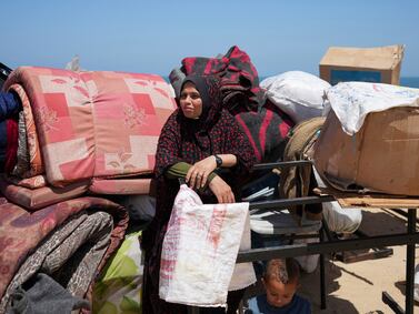Displaced Palestinians arrive in central Gaza after fleeing from Rafah on Thursday.  AP