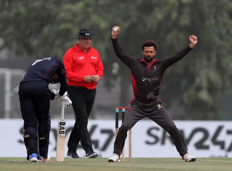 UAE bowler Rohan Mustafa celebrates taking the wicket of Namibia's JJ Smit for seven.
