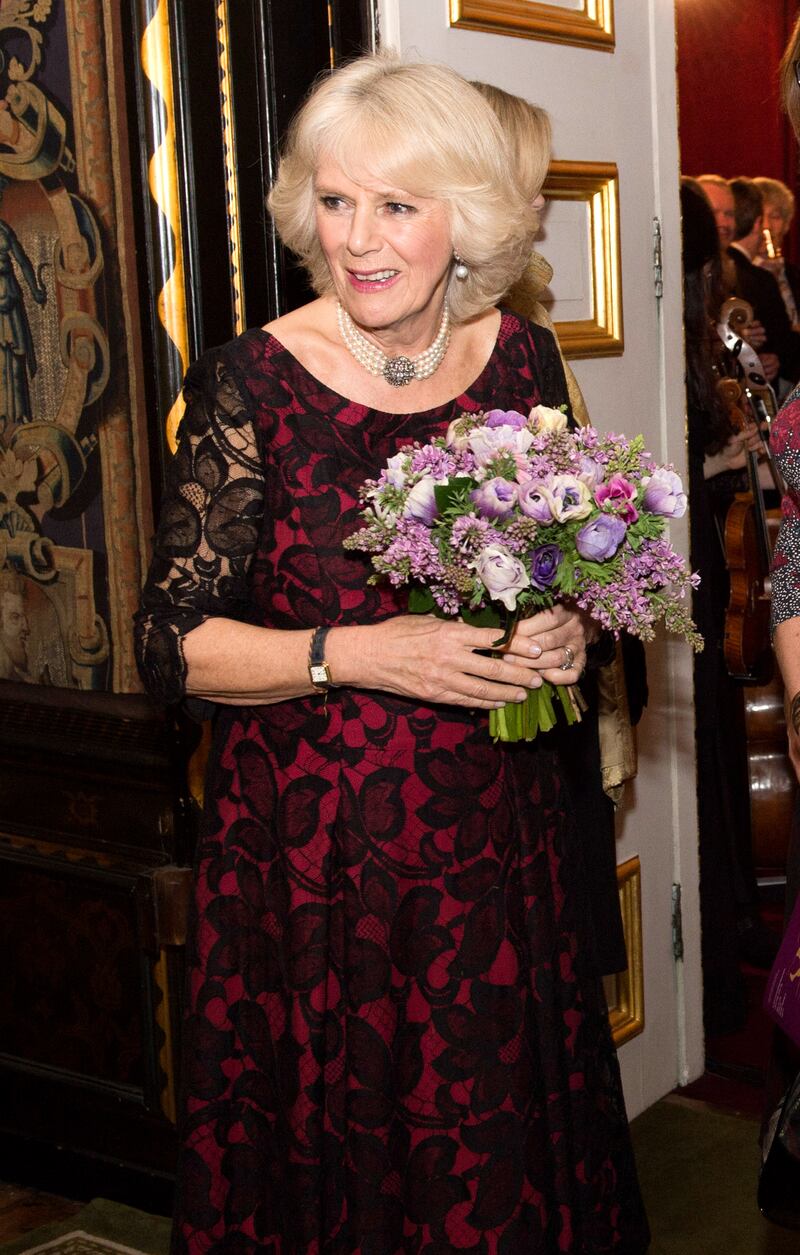 The queen consort, dressed in a black and red lace gown, attends a Gala Concert and Reception to mark the 125th Anniversary of ICAN at St James's Palace on January 21, 2014 in London. Getty Images
