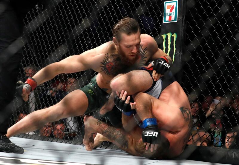 LAS VEGAS, NEVADA - JANUARY 18: Conor McGregor (L) punches Donald Cerrone in a welterweight bout during UFC246 at T-Mobile Arena on January 18, 2020 in Las Vegas, Nevada. McGregor won by first-round TKO.   Steve Marcus/Getty Images/AFP