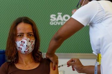 A nurse administers a dose of the SinoVac vaccine to a medical worker at Hospital das Clinicas of the University of Sao Paulo on January 18, 2021 in Sao Paulo, Brazil. Miguel Schincariol / Getty Images)