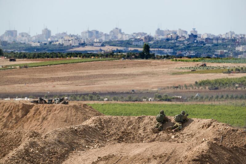 Israeli soldiers observe the Gaza Strip border, Saturday, Oct. 27, 2018. The Israeli military has struck dozens of targets across the Gaza Strip in response to heavy rocket fire and threatened to expand its air campaign to Syria after accusing Iranian forces in Damascus of orchestrating the rocket attacks. (AP Photo/Tsafrir Abayov)