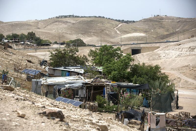  The Jewish settlement of Kfar Adumim is seen on the hill overlooking the tiny West Bank Beduin village of Khan al-Ahmar  on May 2,2018.The Israeli Supreme Court is expected next week to rule on the fate of the village, situated east of Jerusalem between the expanding settlements of Maale Adumim and Kfar Adumim.  The Israeli state says Khan al-Ahmar must be leveled because its structures are situated on state land and were built without permits, which are nearly impossible to obtain in the part of the West Bank known as area C, under full Israeli control.(Photo by Heidi Levine for The National).