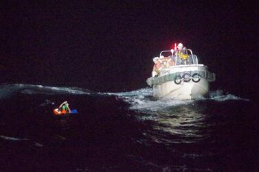 A Filipino sailor is rescued by the Japanese coastguard after a ship carrying livestock and dozens of crew members capsized in the East China Sea during Typhoon Maysak. Japan Coast Guard / Handout via Reuters