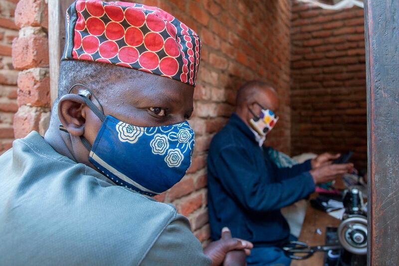 A man wears a face mask as preventive measure against the COVID-19 coronavirus inside Lilongwe City market in Lilongwe on May 18, 2020.  / AFP / AMOS GUMULIRA
