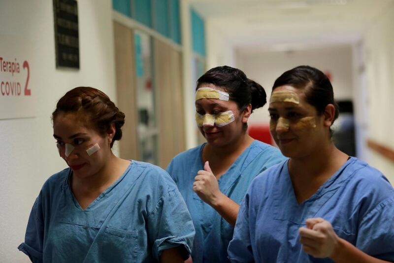 Nurses with goggle marks and plasters on their faces walk after their shift at the intensive care unit where patients with COVID-19 are treated at Juarez hospital, as the coronavirus disease (COVID 19) continues in Mexico City, Mexico. REUTERS