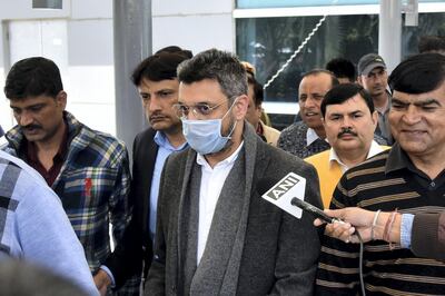 In this picture taken on February 13, 2020, Sanjeev Chawla (C), who was allegedly involved in a match-fixing racket that was busted by the Delhi Police in 2000, is escorted out of the Indra Gandhi International Airport upon his extradition from London, in New Delhi. - The head of India's cricket anti-corruption watchdog said on February 14 that Britain's extradition of accused match-fixer Sanjeev Chawla is "a legal landmark". (Photo by - / AFP)