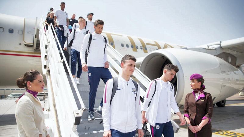 Phil Foden and Brahim Diaz step on to the tarmac, with Aro Muric behind. Courtesy Manchester City