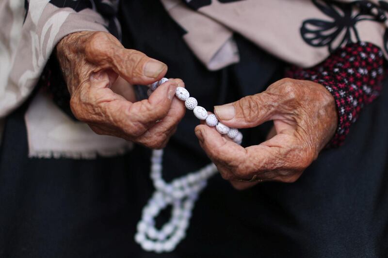 Palestinian refugee woman Freza Al-Gouhl, 79, who witnessed the 1948 Nakba, holds a prayer bead-roll as she sits in her house at Beach refugee camp, as Palestinians mark the event online amid the coronavirus disease (COVID-19) restrictions, in Gaza City May 14, 2020. REUTERS/Mohammed Salem