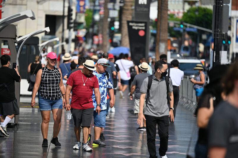 Tourists walk on Hollywood Boulevard's Walk of Fame in Los Angeles. The easing of travel restrictions, imposed by Donald Trump as the Covid-19 pandemic first erupted, will mark a significant shift by President Joe Biden. AFP