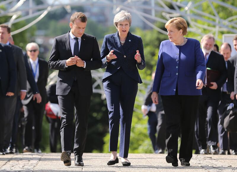 French President Emmanuel Macron, British Prime Minister Theresa May and German Chancellor Angela Merkel walk during the EU-Western Balkans Summit in Sofia, Bulgaria, May 17, 2018. REUTERS/Stoyan Nenov