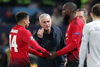 ManU coach Jose Mourinho talks to ManU forward Romelu Lukaku as he replaces teammate Jesse Lingard, left, during the Champions League group H soccer match between Manchester United and Young Boys at Old Trafford Stadium in Manchester, England, Tuesday Nov. 27, 2018. (AP Photo/Jon Super)