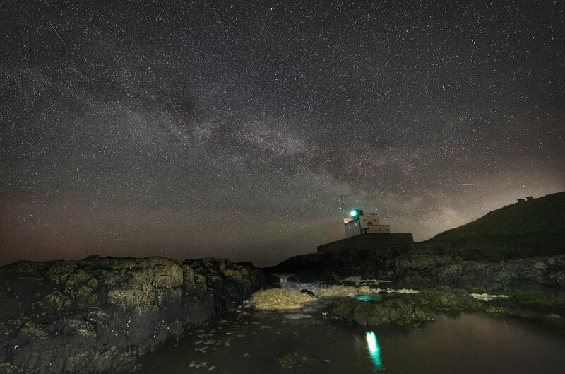 The Milky Way shines over Bamburgh Lighthouse in Northumberland, north-east England. PA
