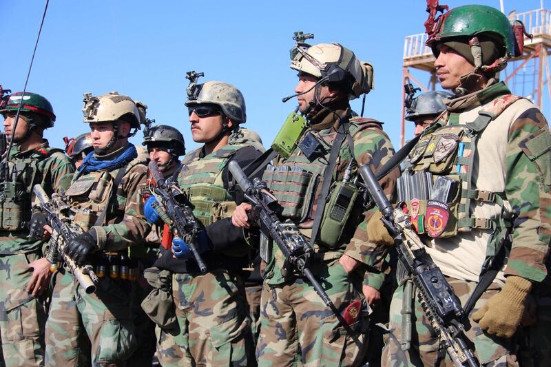 Afghan Army soldiers man a check point in Helmand as Afghan President Ashraf Ghani says a seven-day reduction in violence promised by the Taliban will determine the government's next steps in the peace process. EPA