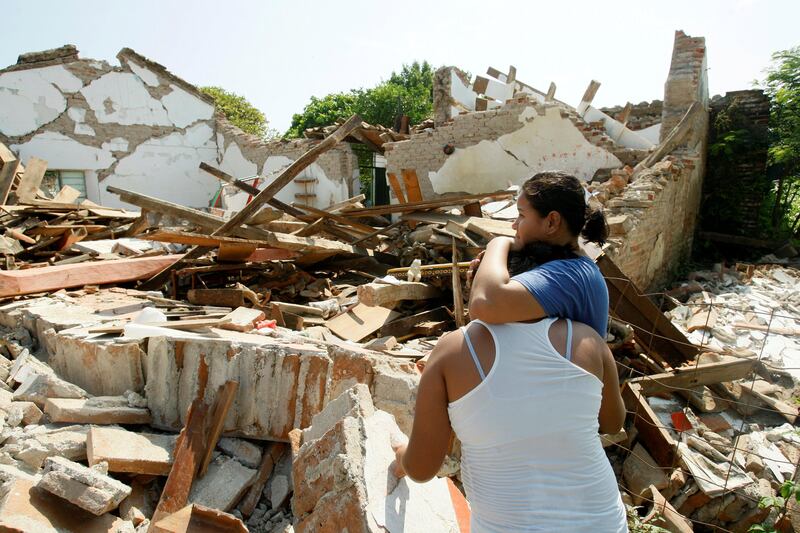 Women hug while standing next to a destroyed house after an earthquake struck the southern coast of Mexico late on Thursday, in Union Hidalgo, Mexico September 9, 2017. REUTERS/Jorge Luis Plata     TPX IMAGES OF THE DAY