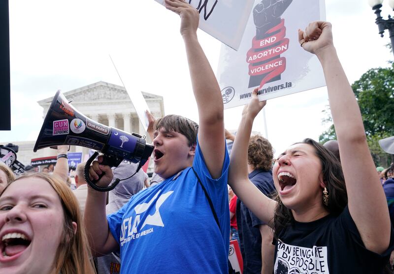 People celebrate outside the Supreme Court. AP