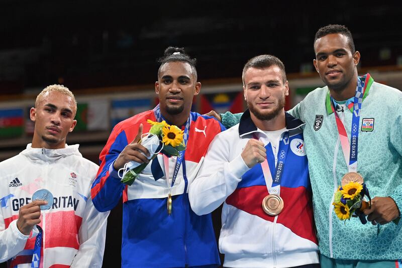 Silver medallist Benjamin Whittaker of Britain, gold medallist Arlen Lopez of Cuba, bronze medallists Russia's Imam Khataev and Azerbaijan's Loren Berto Alfonso Dominguez.