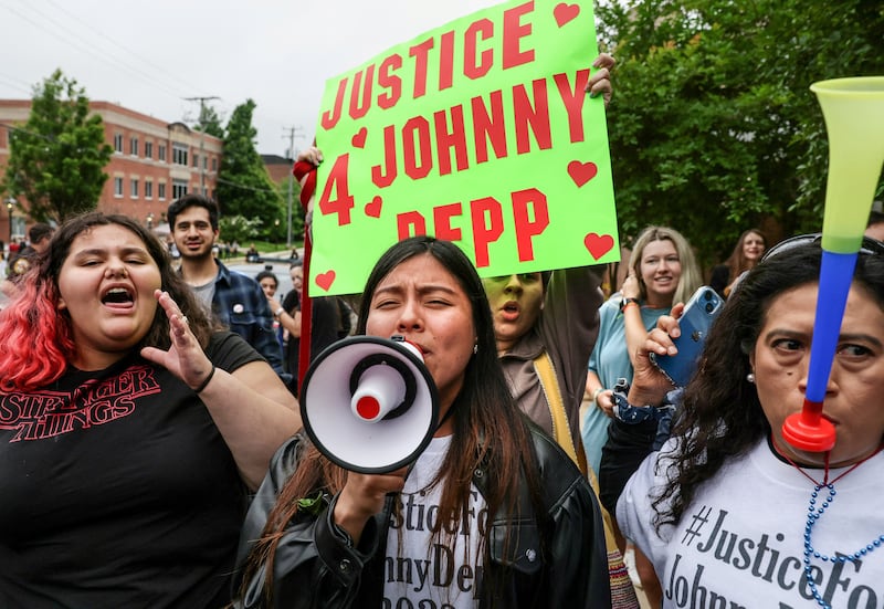 Depp fans cheer outside the courthouse. Reuters