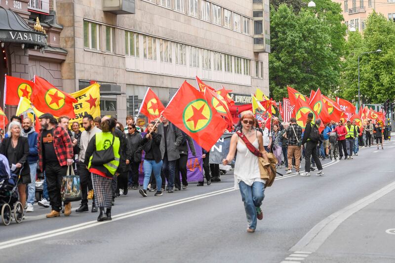 Activists carry flags with the logo of Kurdistan Workers' Party PKK in Stockholm. AFP