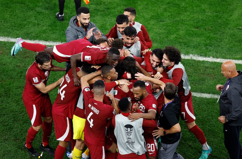 Qatar's Akram Afif is mobbed after scoring their second goal. Reuters