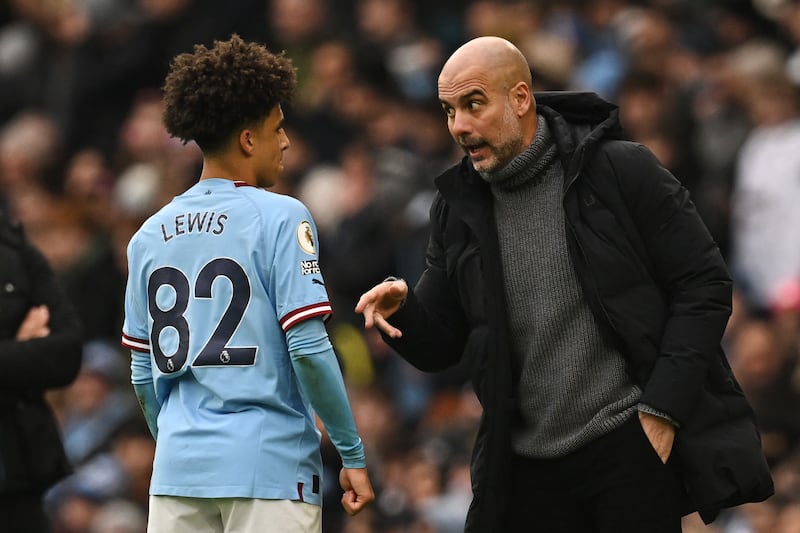 Manchester City manager Pep Guardiola speaks to Rico Lewis. AFP