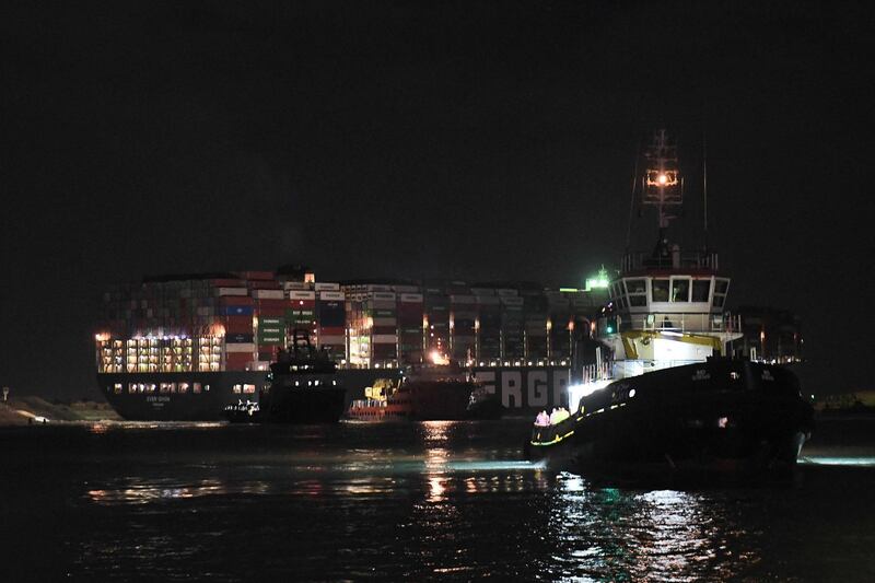 Tugboats by the Panama-flagged MV Ever Given. AFP