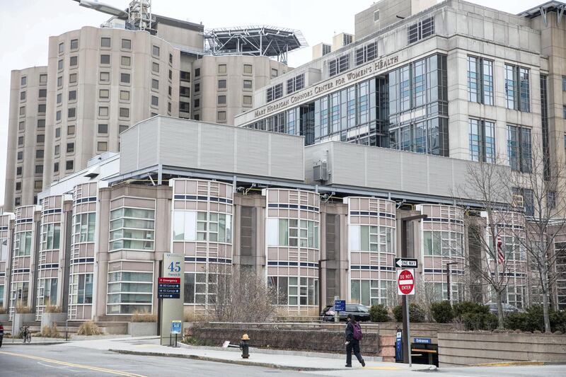 A pedestrian walks past the Brigham and Women's Hospital in Boston, Massachusetts, U.S., on Thursday, March 12, 2020. Whether the situation here becomes as dire as Italy -- or infections remain more restrained -- will depend on research efforts and Boston's public-health initiatives to slow down the spread of the coronavirus. Photographer: Scott Eisen/Bloomberg via Getty Images