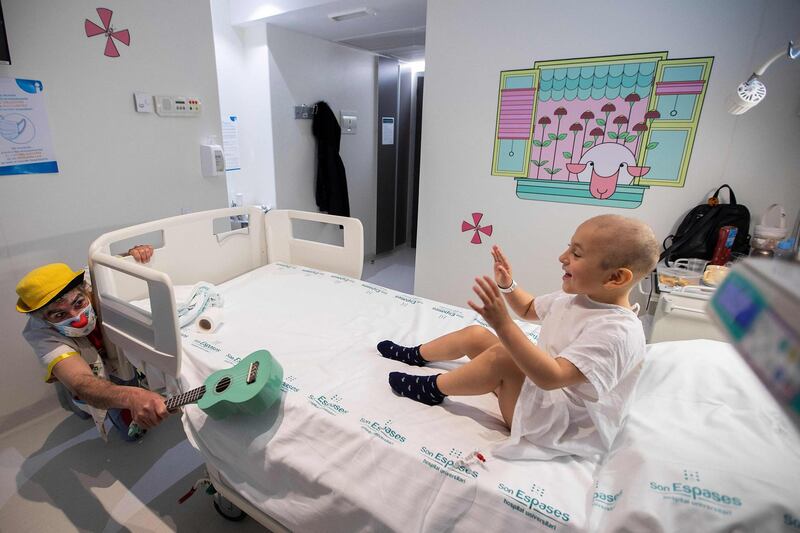 A clown from the Sunrise Media NGO performs for a young patient, at the children´s wing of Son Espases Hospital, in Palma de Mallorca, Spain. AFP