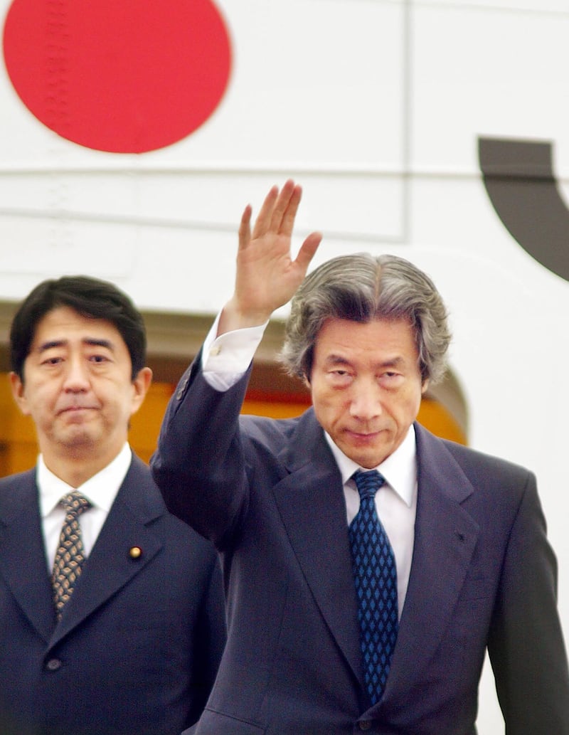 This file photo taken on September 17, 2002 shows Japanese Prime Minister Junichiro Koizumi, accompanied by then-Vice Cabinet Secretary Shinzo Abe as he leaves Tokyo International Airport for Pyongyang to meet with then-North Korean leader Kim Jong Il. AFP