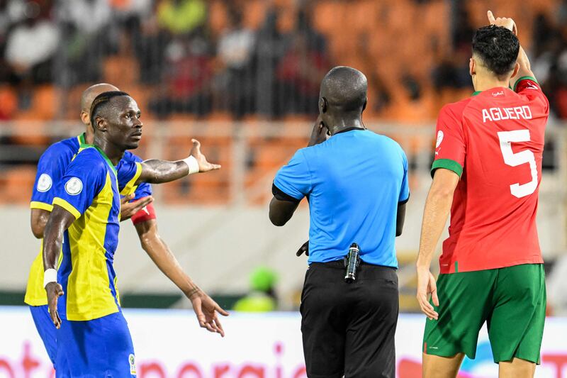 Tanzania's defender Novatus Miroshi speaks with referee Al Hadi Allou Mahamat. Miroshi was sent off in the second half. AFP
