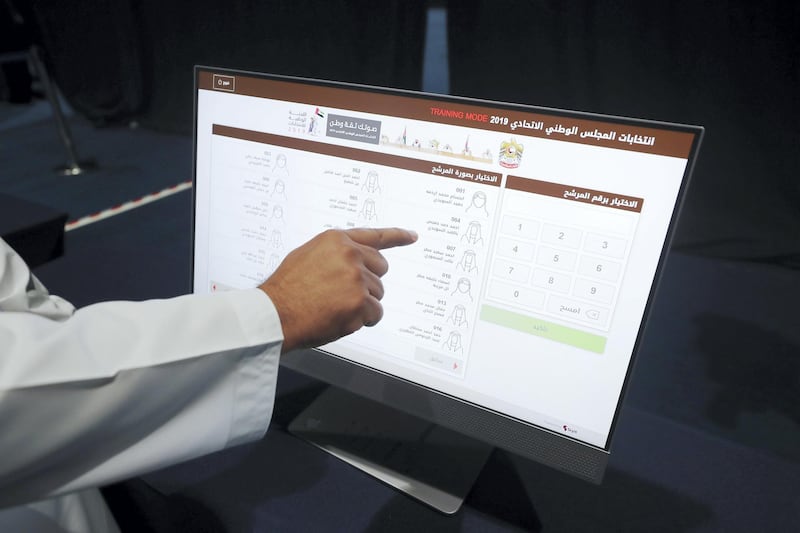 Abu Dhabi, United Arab Emirates - October 01, 2019: People are taught how to use the system (not voting). Early FNC voting takes place. Tuesday the 1st of October 2019. ADNEC, Abu Dhabi. Chris Whiteoak / The National