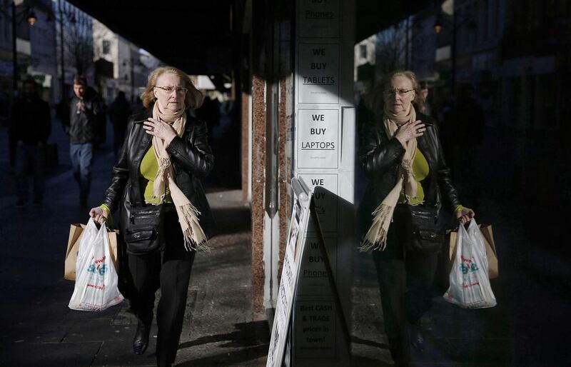 A pedestrian walks along King Street, the main shopping street in Kilmarnock. Suzanne Plunkett / Reuters