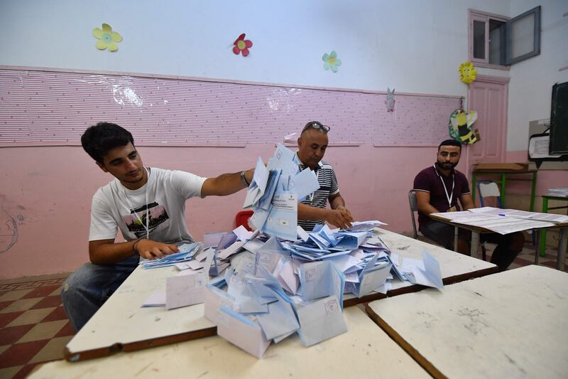 Employees of the Independent Higher Authority for Elections begin counting the ballots. AFP