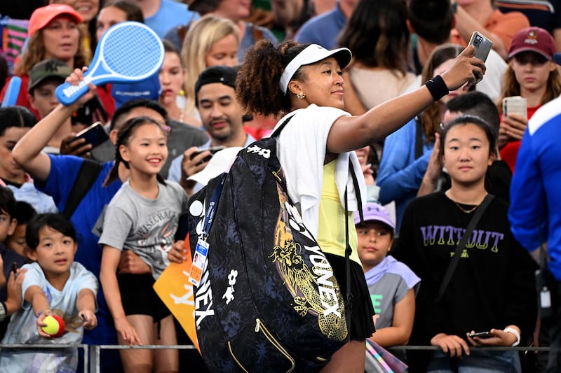 Naomi Osaka takes a selfie with fans in Brisbane. AFP