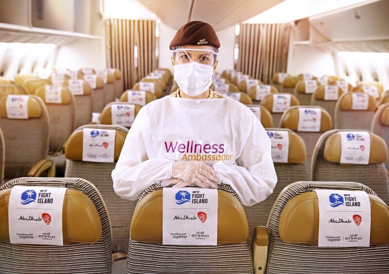Etihad Wellness Ambassador prepares to welcome passengers on board an Etihad aircraft. Courtesy of Etihad Airways