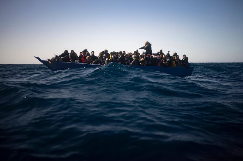 Migrants from Eritrea, Egypt, Syria and Sudan, wait to be assisted by aid workers of the Spanish NGO Open Arms, after fleeing Libya onboard a precarious wooden boat in the Mediterranean sea. AP Photo