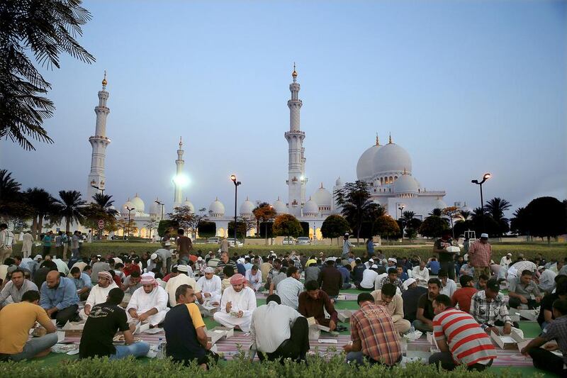 Muslims break their fast on the first day of Ramadan outside Sheikh Zayed Grand Mosque in Abu Dhabi. Ravindranath K / The National