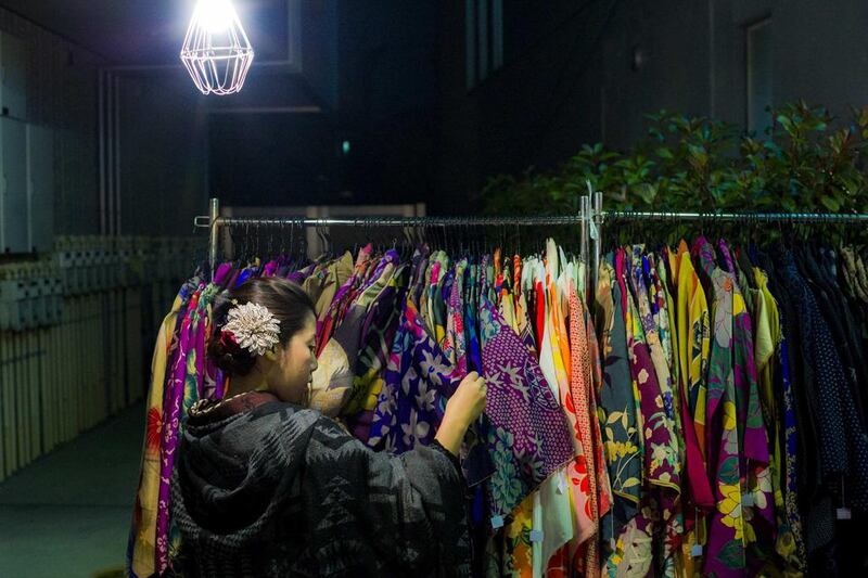 A woman browses through kimonos for sale at the Boroichi flea market in Tokyo. Vintage kimonos in vermillion red and prints of cranes go for as little as ¥1,000. Thomas Peter / Reuters