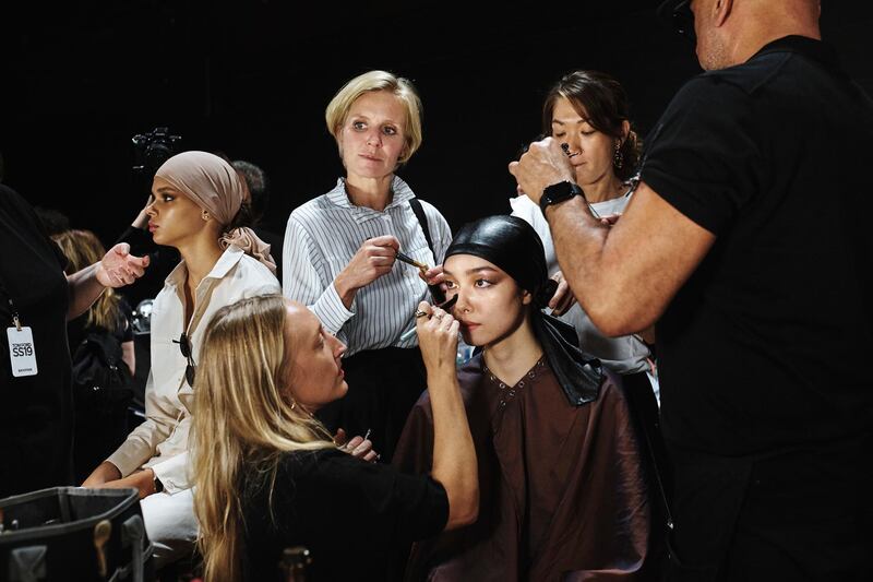 Makeup artists work on models backstage at the Tom Ford show during Fashion Week in New York, Wednesday, Sept. 5, 2018. (AP Photo/Andres Kudacki)