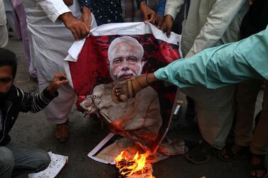 People burn picture of Indian Prime Minister Narendra Modi after reports of Pakistani Air Forces shooting down India fighter jets, in Karachi, Pakistan, 27 February 2019. EPA