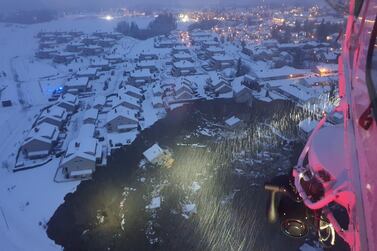 A rescue helicopter hovers over the site of a landslide in Ask on December 30, 2020. The village is about 25 kilometres north of the Norwegian capital Oslo. Norwegian Rescue Service via Reuters