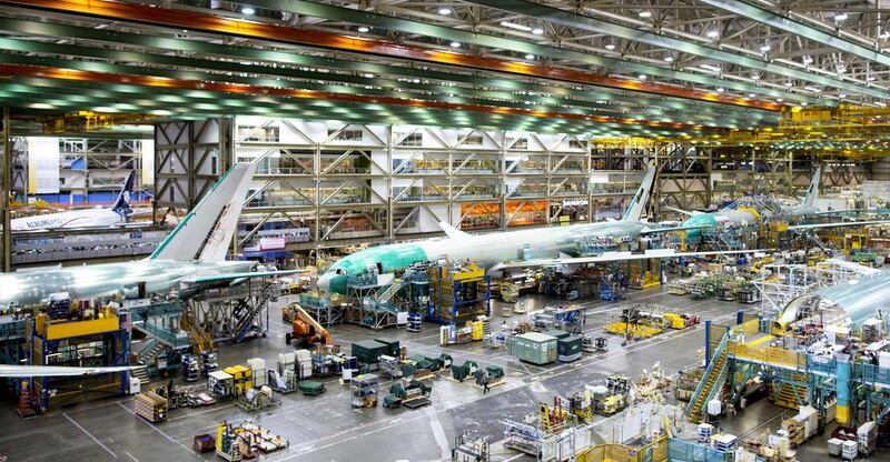 Above, workers assemble 777 aircraft at Boeing's assembly facility in Everett, Washington. Mike Kane / Bloomberg via Getty Images