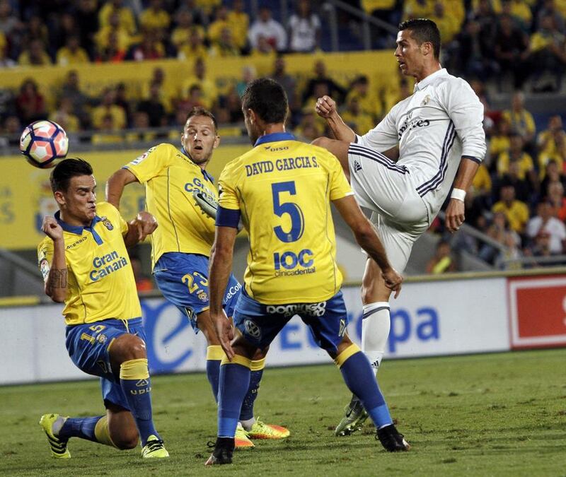 Real Madrid’s Cristiano Ronaldo, right, fights for the ball with Las Palmas players David Garcia, second right, Roque Mesa, left, and Dani Castellano. Angel Medina / AFP