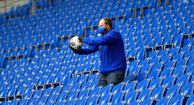 A ball boy retrieves the ball from the empty stands in Gelsenkirchen. EPA