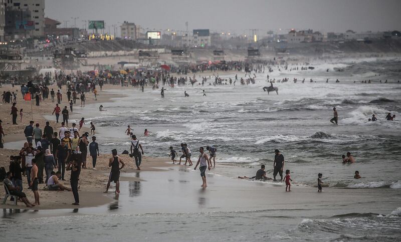 Palestinian families enjoy their time during the Friday holiday, at the Gaza beach in western Gaza Strip.  EPA