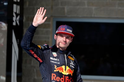 Red Bull's Max Verstappen waves on the podium after winning the 2021 United States Grand Prix. AFP