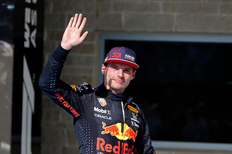 Red Bull's Dutch driver Max Verstappen waves on the podium after winning the Formula One United States Grand Prix at the Circuit of The Americas in Austin, Texas, on October 24, 2021.  AFP