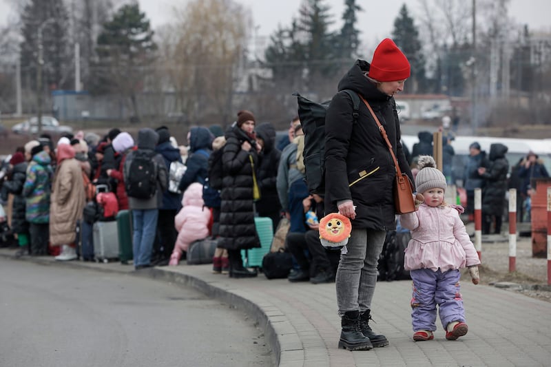 People who fled Ukraine wait for a bus to take them to the train station in Przemysl, at the border crossing in Medyka, Poland. AP Photo